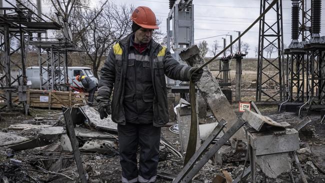 Workers repair infrastructure in a power plant on Friday that was damaged by a Russian air attack in the Kyiv region of Ukraine. Electricity and heating outages across Ukraine caused by missile and drone strikes to energy infrastructure have added urgency preparations for winter. Picture: Ed Ram / Getty Images