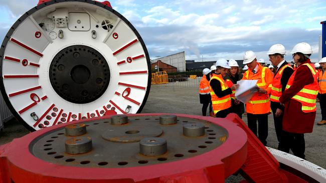 Acting Premier James Merlino and the roads minister Luke Donnellan inspect a new tunnel boring machine. Picture: Nicole Garmston