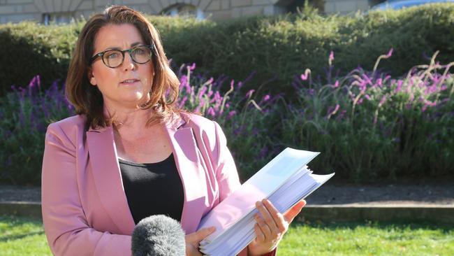 Independent MLC Meg Webb with a dossier of evidence not available to the Blake Review, as she speaks to the media on Parliament Lawns in Hobart on Wednesday, April 17, 2024.