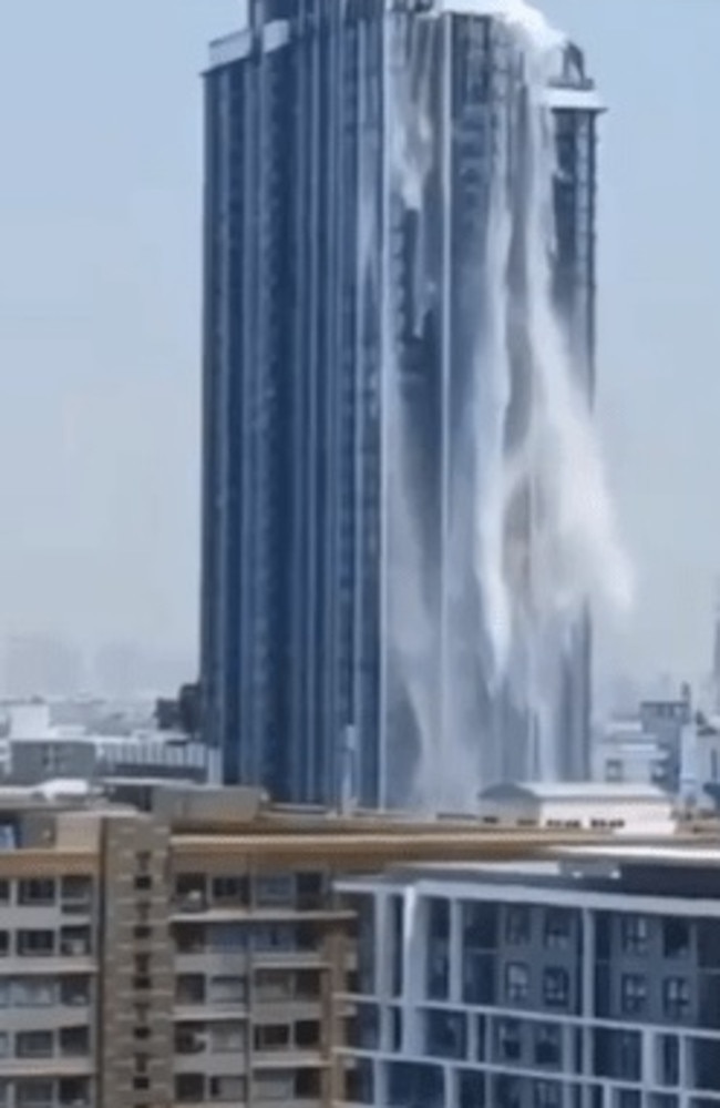 Rooftop pools turned into waterfalls at luxury high-rise apartment buildings in Bangkok as water sloshed onto the street. Picture: X