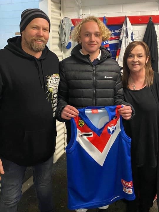 Onkaparinga Valley’s Tyson Paech is presented with his guernsey by his parents, Steven and Melissa, ahead of making his A grade debut against Echunga. Picture: Supplied, Onkaparinga Valley Football Club Facebook page