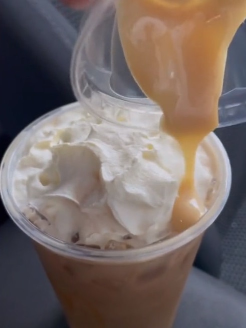 She added whipped cream to her iced long black, before adding the sauce. Picture: TikTok/BecHardgrave