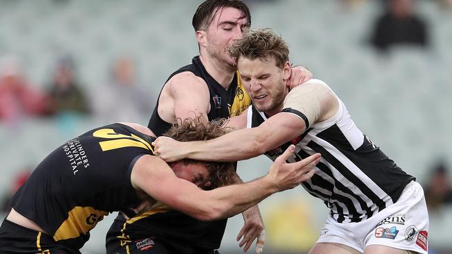 Trent McKenzie comes to grips with Glenelg’s Will Gould (left) and Liam McBean in the SANFL second semi-final. Picture: SARAH REED.