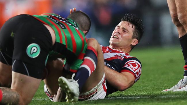 Roosters halfback Cooper Cronk hits the deck after an Adam Reynolds tackle. Picture. Phil Hillyard