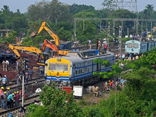 Policemen inspect the wrecked carriages of a three-train collision near Balasore, in India's eastern state of Odisha. Picture: AFP