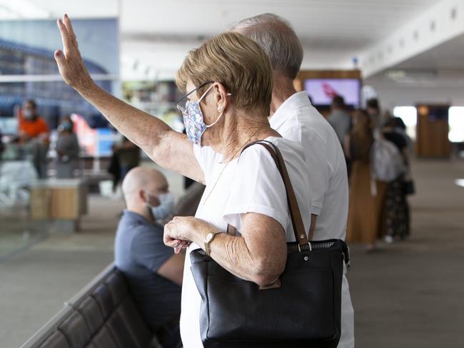 ADELAIDE, AUSTRALIA - Advertiser Photos FEBRUARY 1 Monday 2021: Mary Smith (0428261111) and husband Kevin Smith wave farewell to their daughter Leanne Smith as she boards the Qantas flight QF885 departing Adelaide to Perth at 11am this morning from Gate 24. Adelaide Airport. S.A.SA has shut to WA without public warning. Anyone who arrived in SA from WA after 10.15pm last night without an exemption will be turned away. Anyone who visited WA from Jan 26 needs to go into immediate 14 day quarantine.Picture: Emma Brasier.