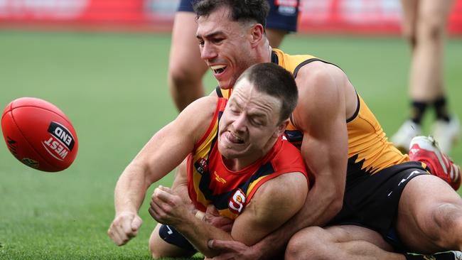 The SANFL’s James Rowe flicks out a handball under pressure against the WAFL. Picture: David Mariuz/SANFL