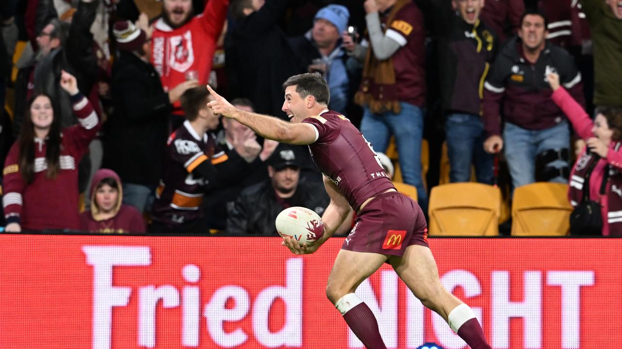 An elated Hunt kicks the ball into the crowd after winning the game, and the series, for the Maroons. Picture: Getty Images.