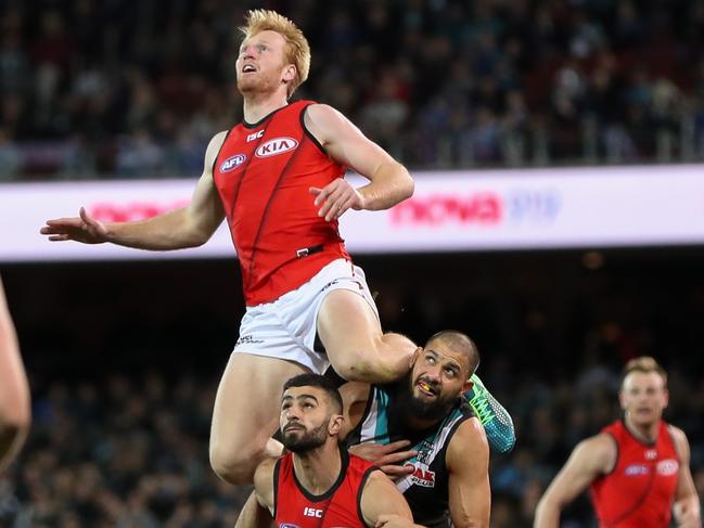 ADELAIDE, AUSTRALIA - AUGUST 24: Aaron Francis of the Bombers marks the ball over team mate Adam Saad and Paddy Ryder of the Power during the 2018 AFL round 23 match between the Port Adelaide Power and the Essendon Bombers at Adelaide Oval on August 24, 2018 in Adelaide, Australia. (Photo by AFL Media)