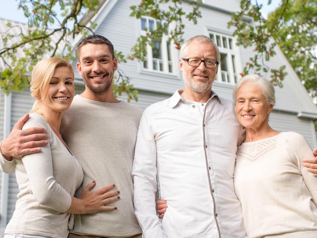family, happiness, generation, home and people concept - happy family standing in front of house outdoors; Bank of Mum and Dad generic money