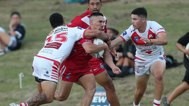 Kincumber’s Luke Heather taking a charge. Picture: Sue Graham