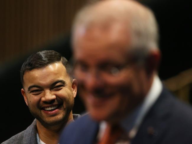 SYDNEY, AUSTRALIA - JUNE 25: Singer Guy Sebastian listens to Prime Minister Scott Morrison during a press conference following a tour of West HQ on June 25, 2020 in Sydney, Australia. The federal government has announced a $250 million support package for the arts and cultural sectors to assist in economic recovery from the COVID-19 pandemic. The funding package includes $90 million in government-backed concessional loans to fund new productions and a $75m grant program that will provide capital to help Australian production and events businesses put on new festivals, concerts, tours and other events as social distancing restrictions ease. (Photo by Matt Blyth/Getty Images)