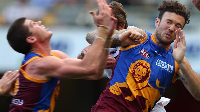 BRISBANE, AUSTRALIA - JULY 17: Jonathan Brown and Mitch Clark of the Lions collide during the round 17 AFL match between the Brisbane Lions and the Geelong Cats at The Gabba on July 17, 2011 in Brisbane, Australia. The Brisbane captain Jonathan Brown has had his face fractured in a sickening collision for the second time this AFL season. (Photo by Chris Hyde/Getty Images)