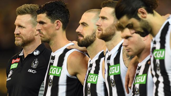 Nathan Buckley side by side with his players. Picture: AAP