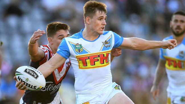 AJ Brimson of the Titans looks to offload a pass as he is tackled by Victor Radley of the Roosters during the Round 12 NRL match. (AAP Image/Dan Himbrechts)