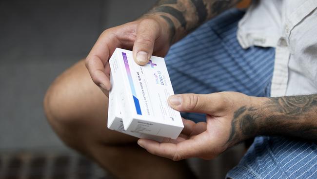 A customer holds his (RAT) rapid antigen tests after purchasing them from a chemist amid low supplies following the surge in Covid cases across the country. Picture: NCA NewsWire / Nikki Short