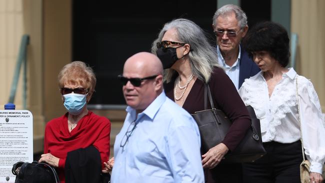 Adam Grimley (in the blue shirt and sunglass at the front of the frame) attendeds a memorial for Melissa Caddick. Picture: John Grainger