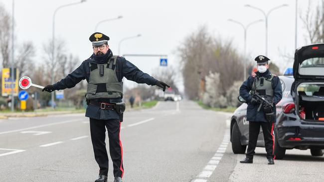 Armed Italian Carabinieri police officers hold a check point between Italian states. Picture: AFP