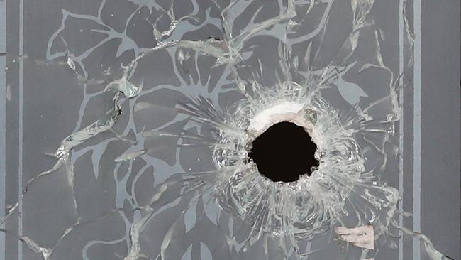 A bullet hole in the glass of the front door after the drive-by shooting that killed a 26-year-old man. Picture: Scott Barbour/Getty Images