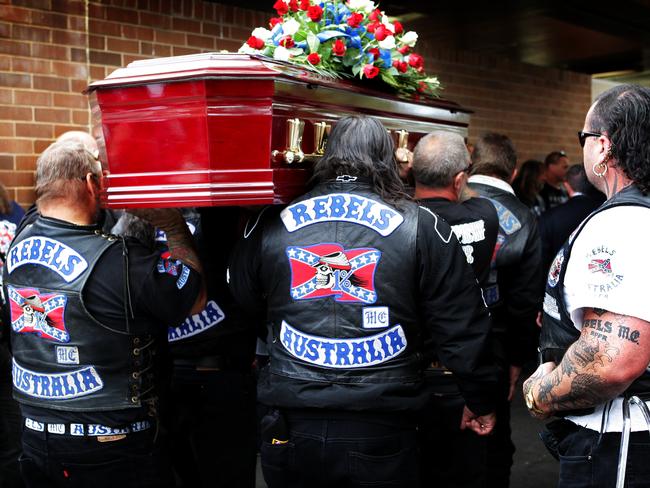 Rebels pallbearers carry the coffin during the funeral service.