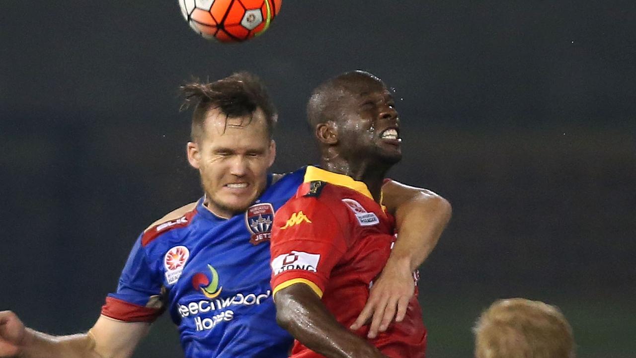 NEWCASTLE, AUSTRALIA - DECEMBER 18: Nigel Boogaard of the Jets contests a header with Bruce DJite of Adelaide during the round 11 A-League match between the Newcastle Jets and Adelaide United at Hunter Stadium on December 18, 2015 in Newcastle, Australia. (Photo by Tony Feder/Getty Images)