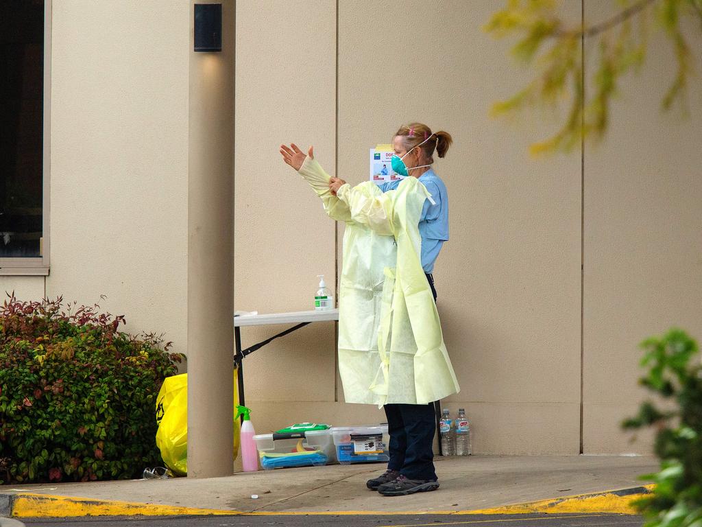 An AUSMAT nurse applies PPE at Kaylna Aged Care in Delahey, Melbourne, after the state government has taken control. Picture: Mark Stewart