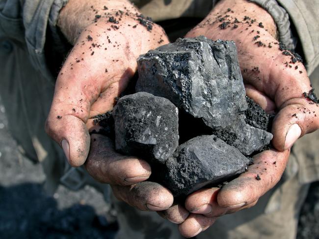 coal miner in the hands of coal background generic
