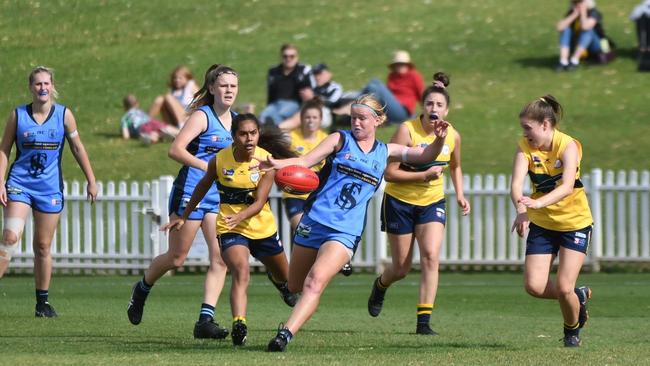 Sturt’s Georgia Swan with the ball being chased by Woodville-West Torrens' Tesharne Maher and Tess Grant. Picture: Peter Swan