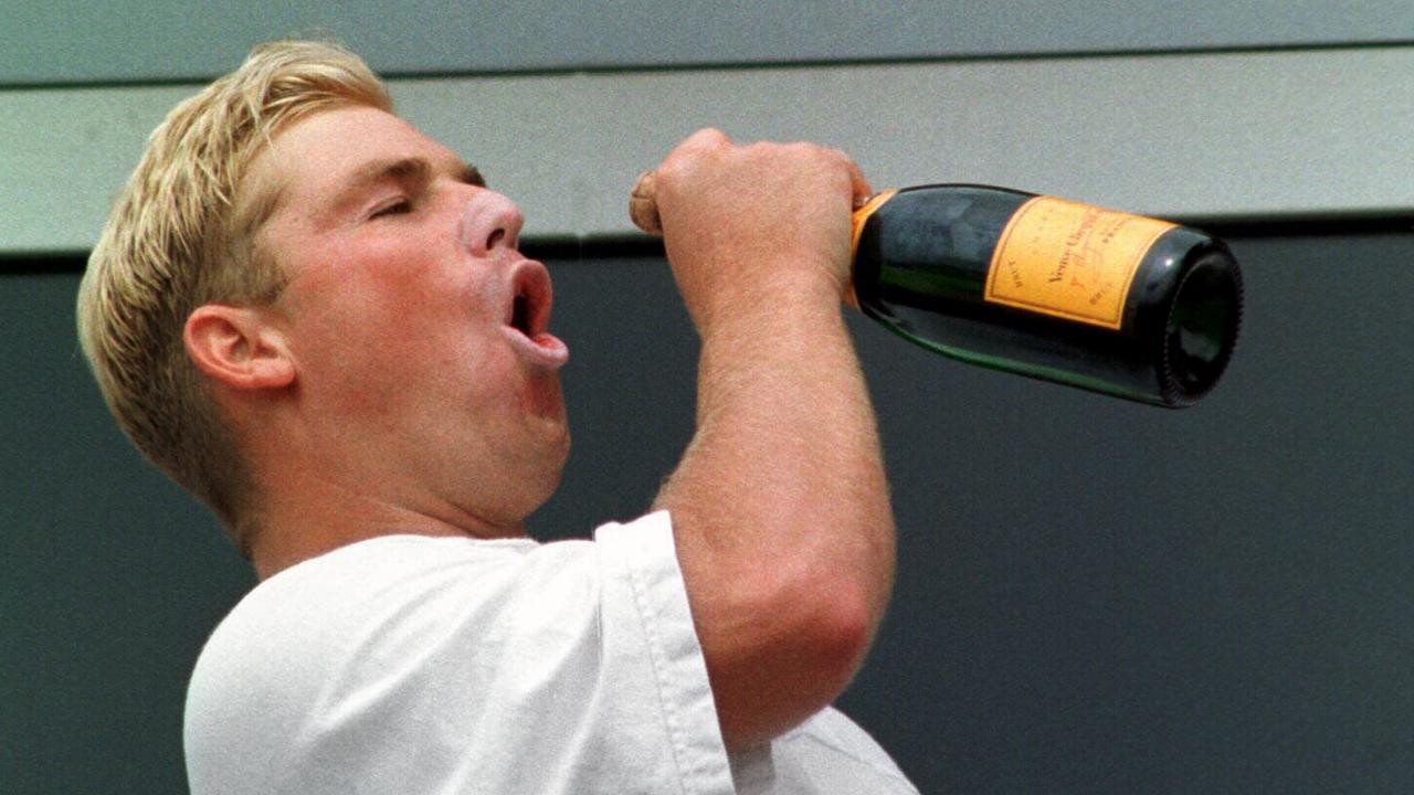 Shane Warne swigs champagne from bottle on Old Trafford balcony during celebration of Aust  win over England in Jul 1997 Ashes series Third Test - Cricket P/R - liquor headshot profile sport o/seas action