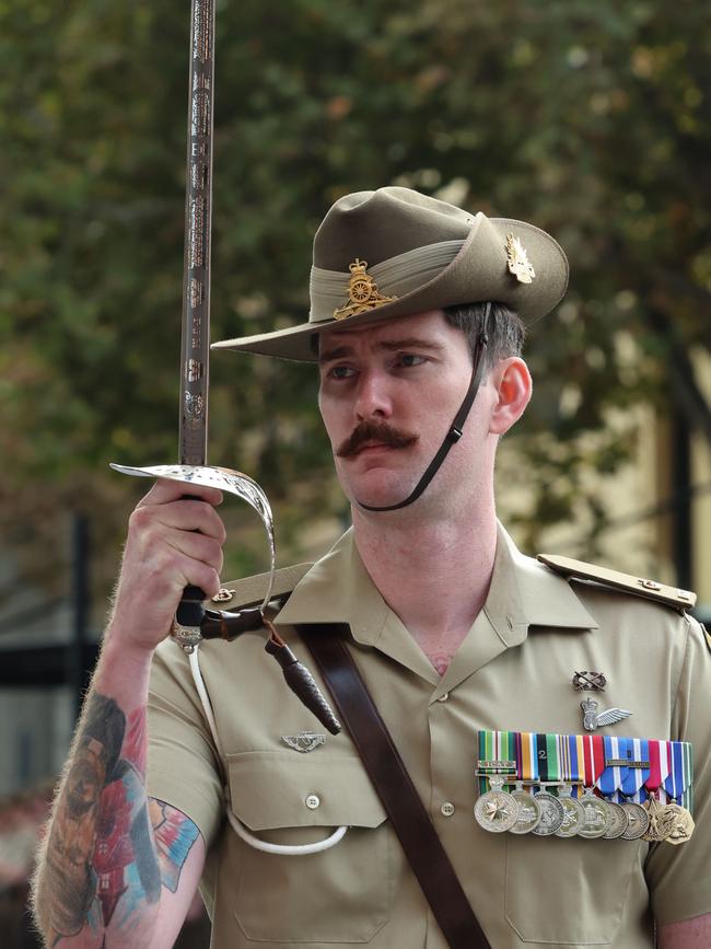 Major Andrew Evans honoured his late friend Capt Paul McKay by carrying his sword in today’s Anzac Day march. Picture: Russell Millard