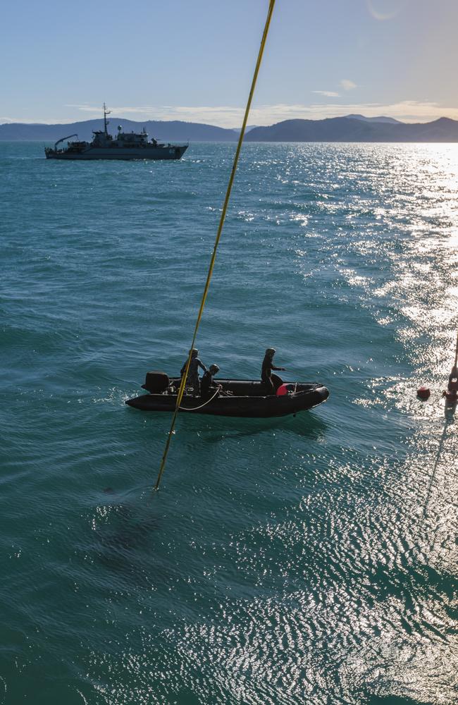 Royal Australian Navy Clearance Divers Chief Petty Officer Andrew Welsh, Able Seaman Joe Cornell and Seaman Tylah Douglas-Ramirez, assist in the recovery of an Australian Army MRH-90 Taipan tail rotor alongside ADV Reliant and HMAS Huon, near Lindeman Island on August 11, 2023. The aircraft was participating in a night-time training activity as part of Exercise Talisman Sabre 2023. Picture: Supplied