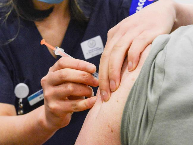 ADELAIDE, AUSTRALIA - NewsWire Photos NOVEMBER 4, 2021: SA Health vaccinator Xuan gives paramedic Sharon Hennessy a Covid booster vaccine at Wayville Vaccination Clinic. Picture: NCA NewsWire/Brenton Edwards