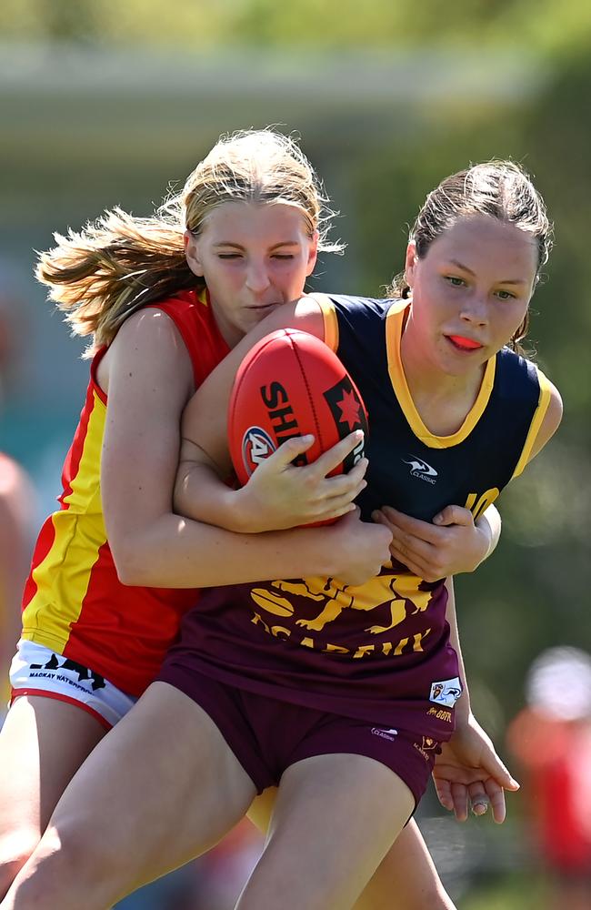 Poppy Tindal of the Lions is tackled by Sunny Lappin . (Photo by Albert Perez/AFL Photos via Getty Images)