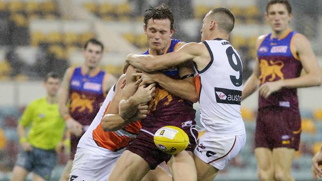 Brisbane’s Ryan Lester is tackled by Tom Scully during the heavy loss to GWS. Picture: Peter Wallis