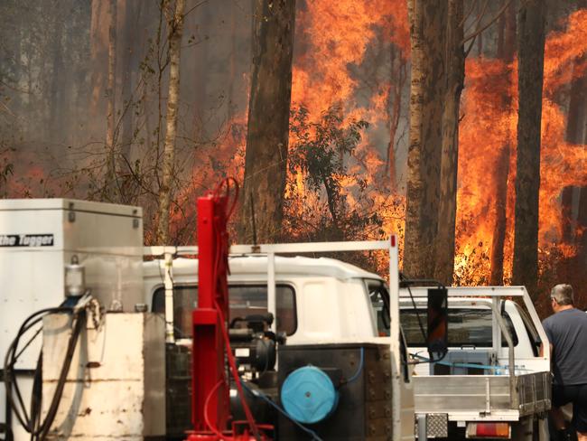 Firefighters battle bushfires in Busbys Flat, northern NSW, Wednesday, October 9, 2019. (AAP Image/Jason O'Brien)