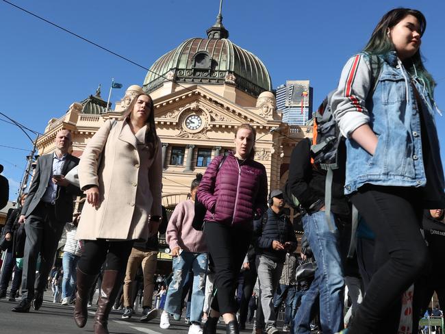 Pedestrians cross the intersection in front of Flinders Street Station in Melbourne, Wednesday, March 6, 2019. The Australian economy grew by a seasonally adjusted 2.3 per cent in 2018 after expanding by a below expectation 0.2 per cent in the December quarter. (AAP Image/David Crosling) NO ARCHIVING