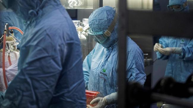 Researchers in protective suits work in a lab at the Yisheng Biopharma company, where researchers are trying to develop a vaccine for COVID-19. Picture: AFP