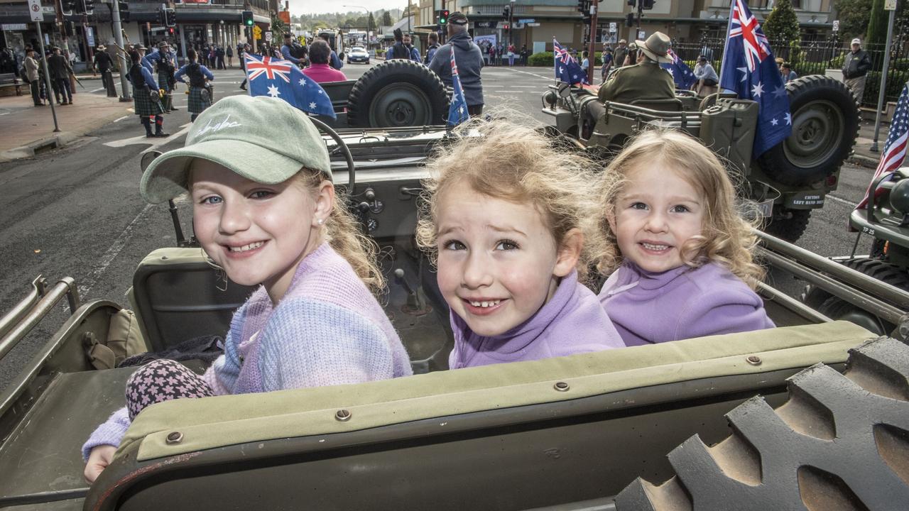 (from left) Peyton Locke with her grandfathers medals, Chloe Connolly and Ella Connolly. Assembly in Neil St for the mid morning parade on ANZAC DAY. Tuesday, April 25, 2023. Picture: Nev Madsen.