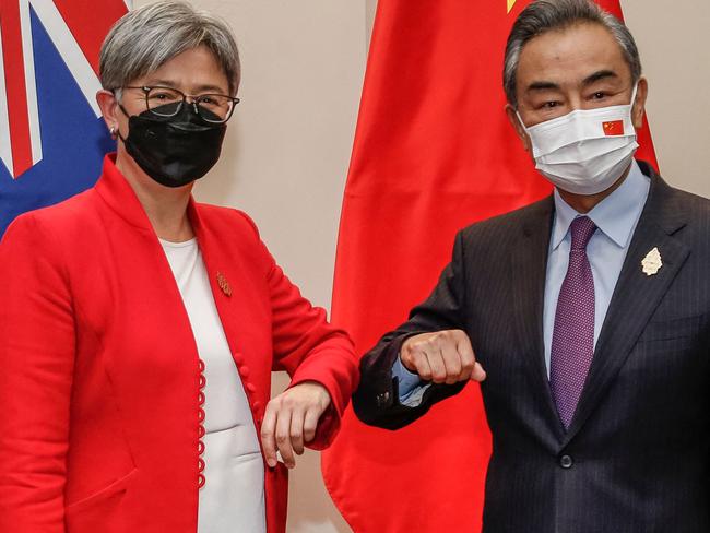 Australia's Foreign Minister Penny Wong bumps elbows with China's Foreign Minister Wang Yi.