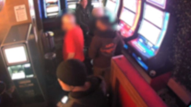 People standing close together inside the pokies area of Bar Cleveland in Redfern