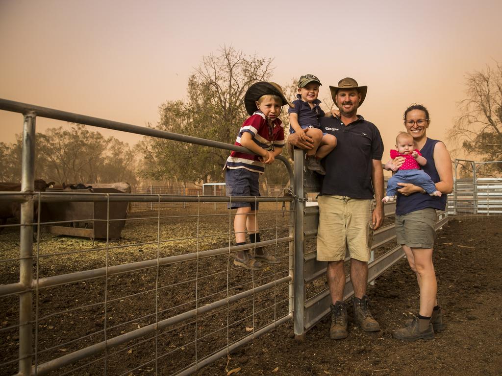 Fourth generation farmer Brad Cox with his wife Katie Cox and their children Georgia Cox, 4 months, James Cox, 2, and Edward Cox, 5, on their property near Collie, north of Dubbo, during a dust storm. Currently in the midst of the worst drought their worst drought on record, they farm sheep, cattle and grain. Picture: Dylan Robinson