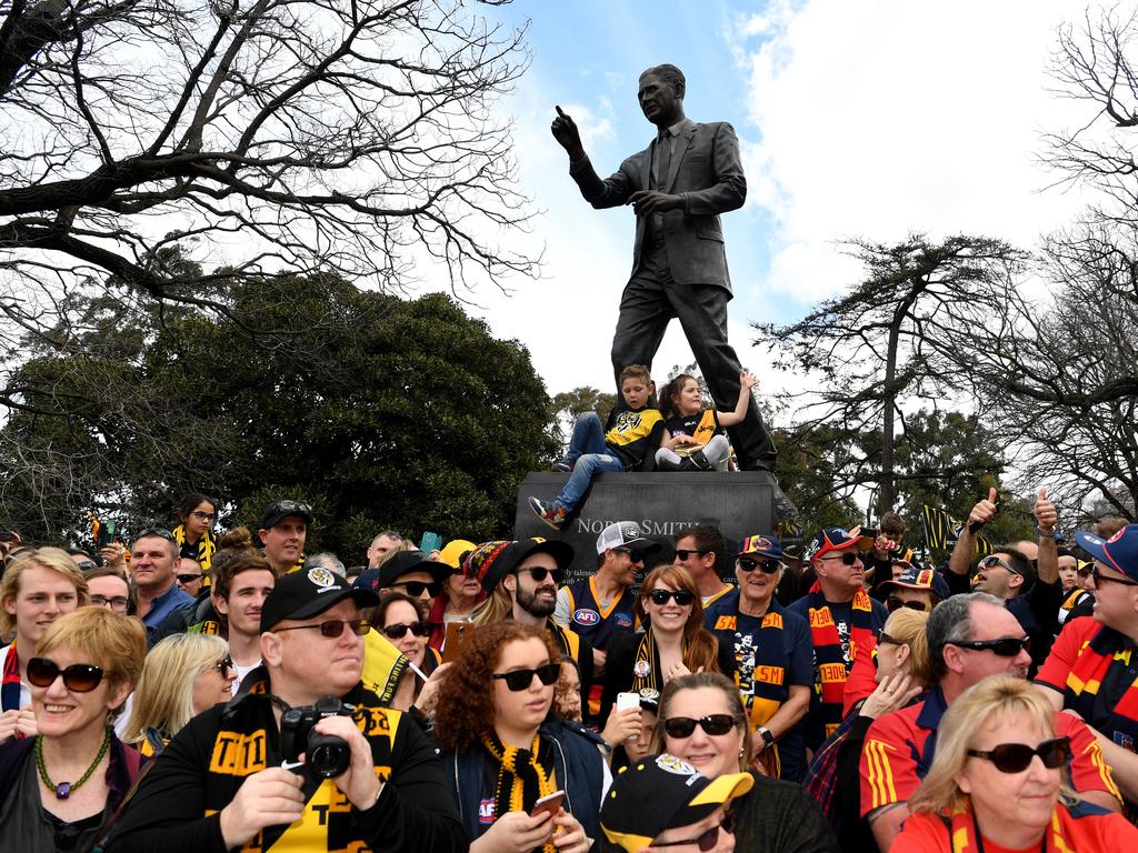 Football fans line up to watch the AFL Grand Final parade on Friday. Picture: AAP Image/Joe Castro