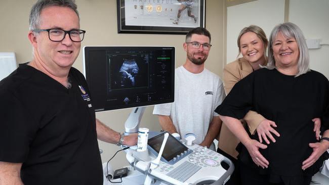 This is a first: Obstetrician Dr Stephen Cole with from left: dad-to-be Corey Macartney, mum-to-be Cassidy Sharp and surrogate grandmother Lisa Sharp. Picture: David Caird