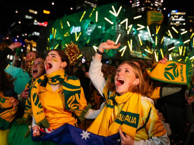 MELBOURNE, AUSTRALIA - AUGUST 07: Australian fans celebrate at Melbourne's Federation Square after watching the Matildas FIFA World Cup win their round of 16 match against Denmark, being played in Sydney, on August 07, 2023 in Melbourne, Australia. (Photo by Asanka Ratnayake/Getty Images)