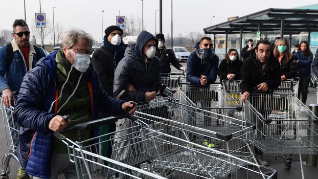 Residents wait to be given access to shop in a supermarket in small groups of 40 in the Italian town of Casalpusterlengo, under the shadow of a new coronavirus outbreak. Picture: AFP