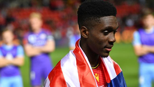 Al Hassan Toure after the FFA Cup grand final with the Liberian flag draped over his shoulders Picture: AAP