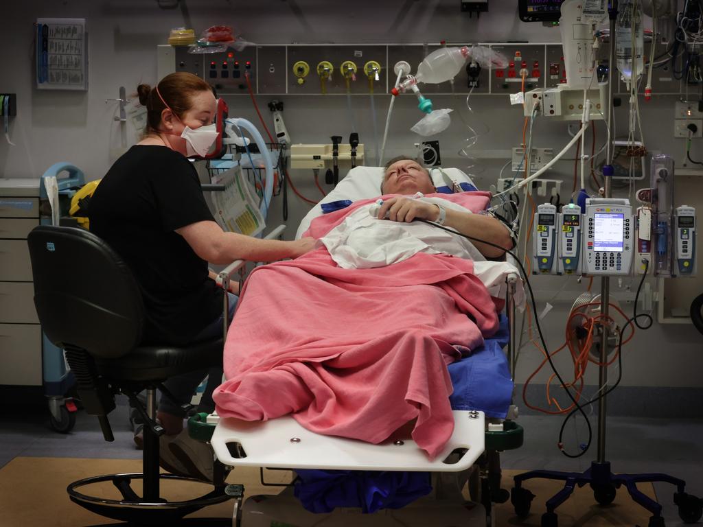 Patient Craig Wallace is comforted by his wife in a trauma room after a motorcycle crash. Picture: David Caird