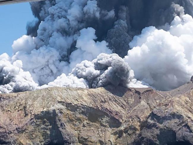 (FILES) This handout file photograph released courtesy of Michael Schade and taken on December 9, 2019 shows the volcano on New Zealand's White Island spewing steam and ash moments after it erupted. - New Zealand Prime Minister Jacinda Ardern on December 9, 2020 paid emotional tribute to victims of the White Island volcano eruption on the first anniversary of the disaster that claimed 22 lives. (Photo by Handout / Michael Schade / AFP) / RESTRICTED TO EDITORIAL USE - MANDATORY CREDIT "AFP PHOTO / COURTESY OF MICHAEL SCHADE" - NO MARKETING NO ADVERTISING CAMPAIGNS - DISTRIBUTED AS A SERVICE TO CLIENTS -- NO ARCHIVES