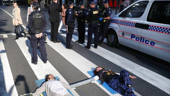 Police in Queen St with protesters Sergio and Ebony. Picture: Liam Kidston