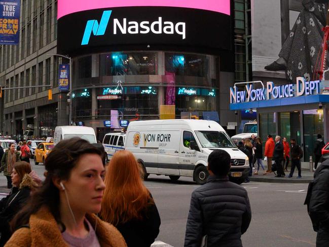 (FILES) In this file photo taken on March 29, 2019 The Lyft logo is shown on the screen at the Nasdaq offices in Times Square in New York. - Uber and Lyft are hoping a courtroom reprieve will spare them from shutting down their rival smartphone-summoned ride services in California on August 21. The companies are awaiting word from an appeals court whether they will be able to delay having to abide by a new state law that officials argue requires them to reclassify drivers as employees entitled to worker benefits. (Photo by Don EMMERT / AFP)